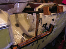 device to press the plywood strips into the transom in place for curing
