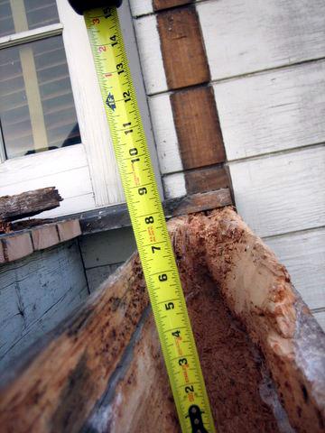 (F) Badly rotted beam/joist with a tape measure