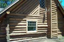 A picture of the side of a log home